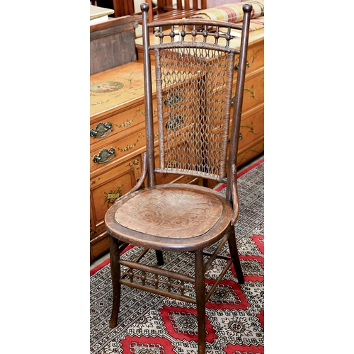 187 - An early 20th century side chair with chain mail rattan back and pressed/embossed seat