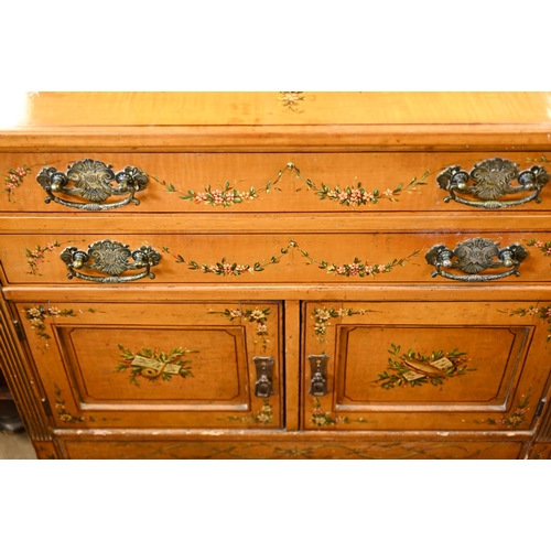 194 - A 19th century satinwood chest with two drawers over panelled cupboard doors painted with classical ... 