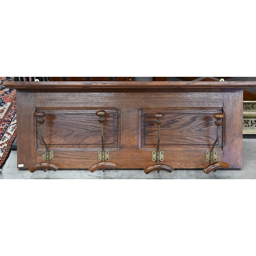 197 - A panelled oak hall shelf with four wrought iron hat/coat hooks, 100 cm wide x 40 cm high to/w a par... 