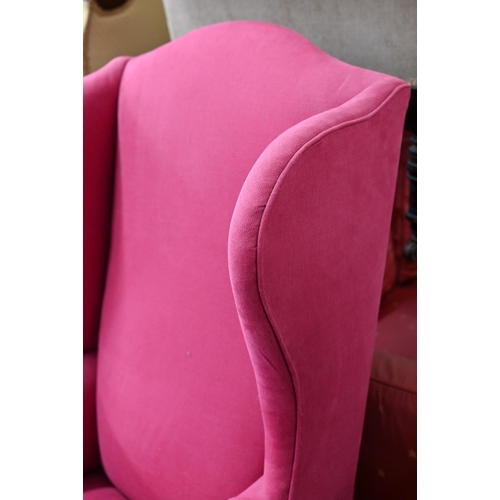 206 - An antique wingback armchair with bright pink fabric upholstery, on mahogany cabriole front legs