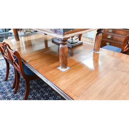 216 - A Victorian mahogany wind-out extending dining table with two leaves, raised on turned and fluted le... 