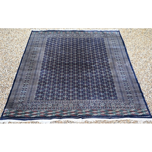 A large Pakistani Turkoman design carpet, the blue ground with ...