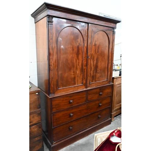 228 - A 19th century mahogany linen press, arch panelled doors enclosing hanging rail (original sides remo... 