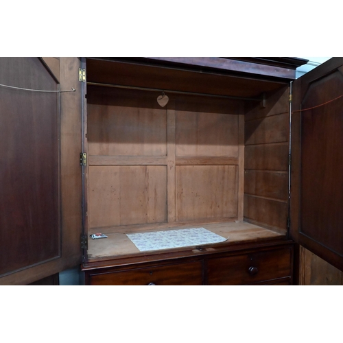 228 - A 19th century mahogany linen press, arch panelled doors enclosing hanging rail (original sides remo... 