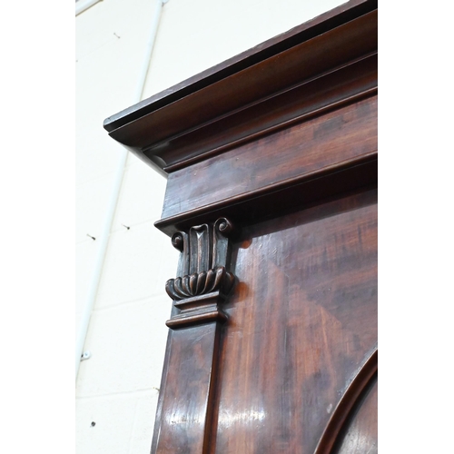 228 - A 19th century mahogany linen press, arch panelled doors enclosing hanging rail (original sides remo... 