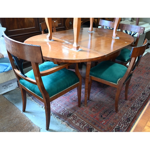 229 - A Biedermeier circular fruitwood table, the top extending to accept one associated leaf to/w a set o... 