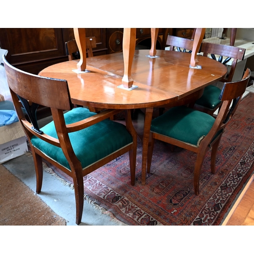 229 - A Biedermeier circular fruitwood table, the top extending to accept one associated leaf to/w a set o... 