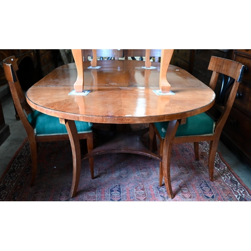 229 - A Biedermeier circular fruitwood table, the top extending to accept one associated leaf to/w a set o... 