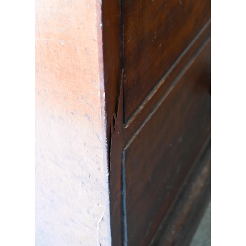 236 - A 19th century mahogany compactum wardrobe, arch panelled doors enclosing hanging space and slides o... 