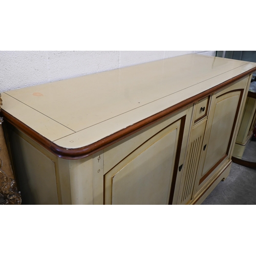 238 - A French cream painted sideboard by Le Creuset, the two panelled cupboard doors separated by fluted ... 