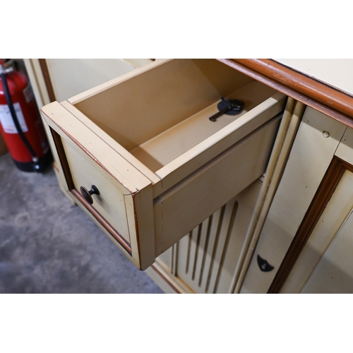 238 - A French cream painted sideboard by Le Creuset, the two panelled cupboard doors separated by fluted ... 