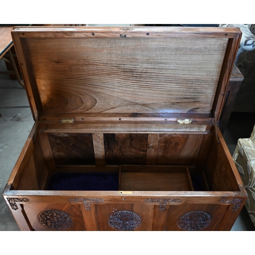 240 - An Indian hardwood blanket chest, panelled construction with foliate caned medallions and borders, s... 