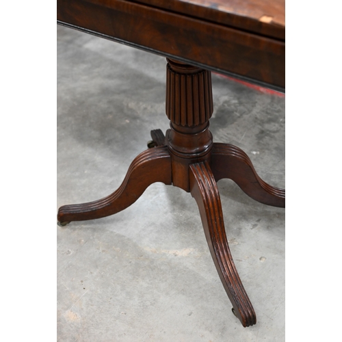 250 - # A 19th century mahogany crossbanded folding tea table on reeded turned column and quadraform base,... 