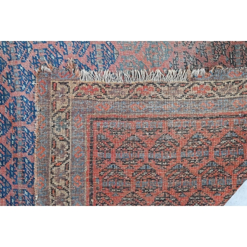 251 - Four old worn Persian rugs - Turkoman with repeat gul design on red ground, 165 x 115 cm; Balouch 15... 