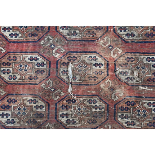 251 - Four old worn Persian rugs - Turkoman with repeat gul design on red ground, 165 x 115 cm; Balouch 15... 