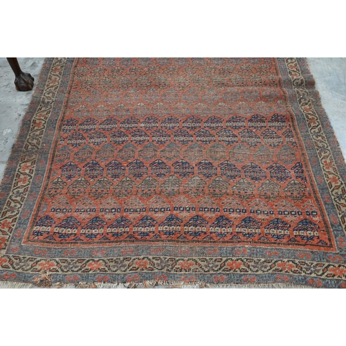 251 - Four old worn Persian rugs - Turkoman with repeat gul design on red ground, 165 x 115 cm; Balouch 15... 