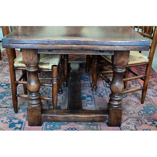 255 - An oak draw-leaf refectory dining table with cleated planked top on turned supports with stretchers,... 