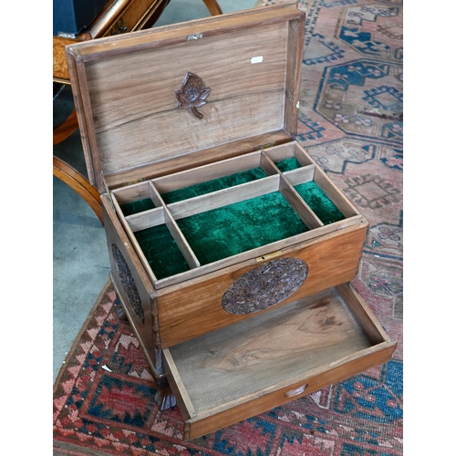 257 - An Indian hardwood sewing/work box with carved floral decoration, 44 x 28 x 40 cm high