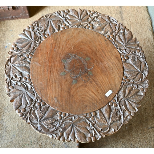 259 - # An Indian carved hardwood occasional table with floral brass inlaid top and folding base, 45 cm di... 