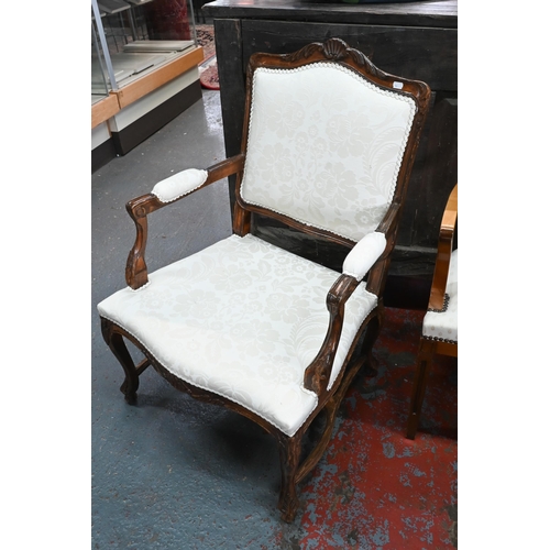 276 - Three differing continental carved walnut framed and fabric panelled salon open armchairs (3)