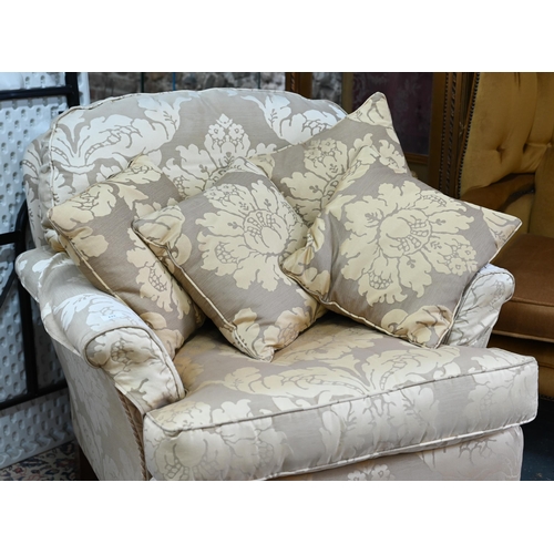 279 - A contemporary cream/gold floral upholstered wing armchair by Duresta to/with an easy armchair in sa... 