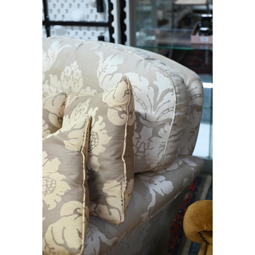 279 - A contemporary cream/gold floral upholstered wing armchair by Duresta to/with an easy armchair in sa... 