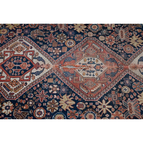 290 - SW Persian Shiraz triple diamond medallion and stylised floral design on navy blue ground, red/cream... 