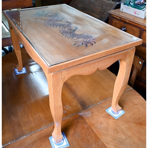 296 - A Chinese hardwood coffee table, the top with copper filigree inset dragon under glass, on shaped su... 