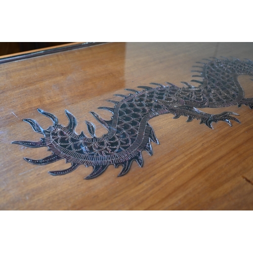 296 - A Chinese hardwood coffee table, the top with copper filigree inset dragon under glass, on shaped su... 