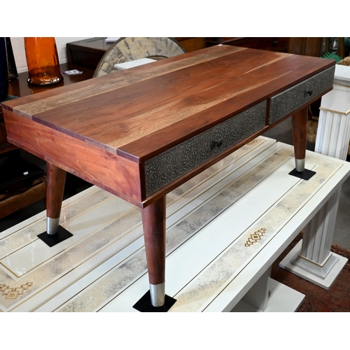 297 - A tropical hardwood coffee table, with four drawers covered with foliate embossed white sheet metal ... 