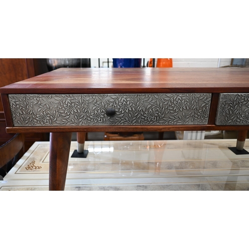 297 - A tropical hardwood coffee table, with four drawers covered with foliate embossed white sheet metal ... 