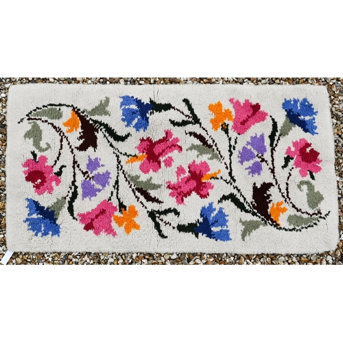 375 - A vintage thick-piled wool floral rug, 134 x 69 cm