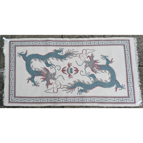 378 - A modern Chinese cut wool pictorial rug with two dragons disputing a flaming pearl on cream ground, ... 