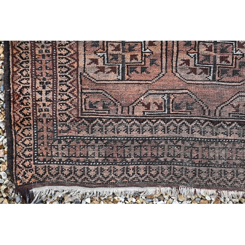 382 - An old Balouchi brown ground rug with repeating octagonal gul design, 212 x 131 cm to/w Afghan rug w... 