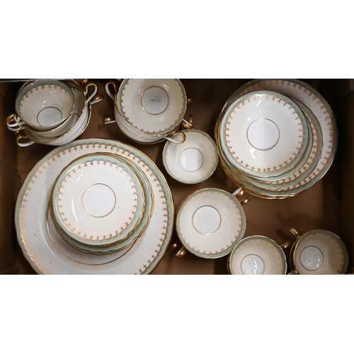 402 - An Aynsley tea/dinner service with cream, green and gilt borders, 54 pieces (box)