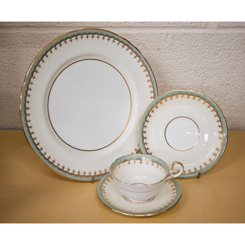 402 - An Aynsley tea/dinner service with cream, green and gilt borders, 54 pieces (box)