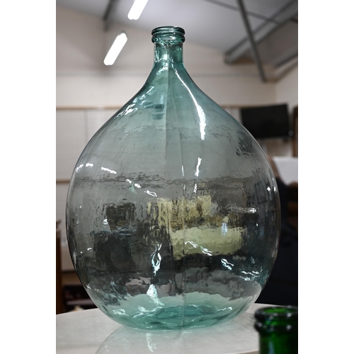 438 - Three green glass carboys, 65 cm high