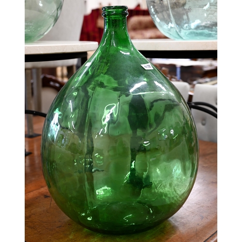 438 - Three green glass carboys, 65 cm high