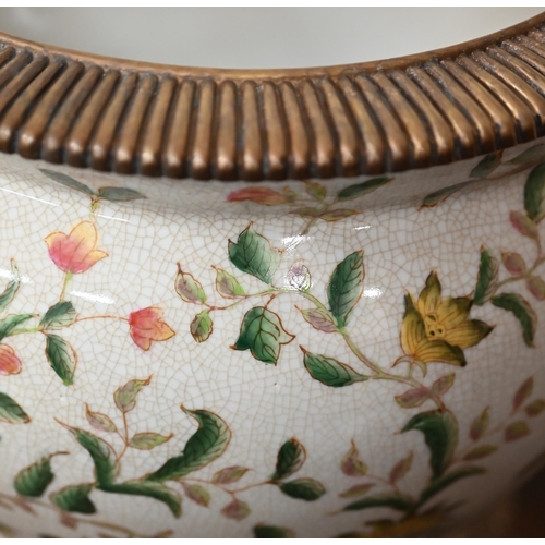 446 - An Asian pottery jardiniere printed with birds, flowers and foliage, with metal rim and foot, 31 cm ... 