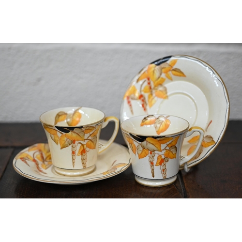 449 - An Art Deco Crown Devon pottery coffee service, printed and painted with wisteria, including coffee ... 