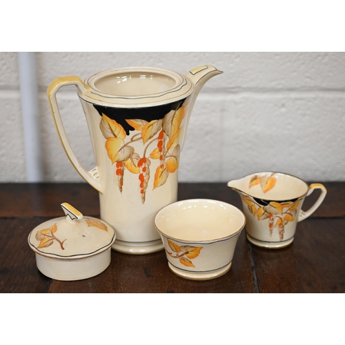 449 - An Art Deco Crown Devon pottery coffee service, printed and painted with wisteria, including coffee ... 