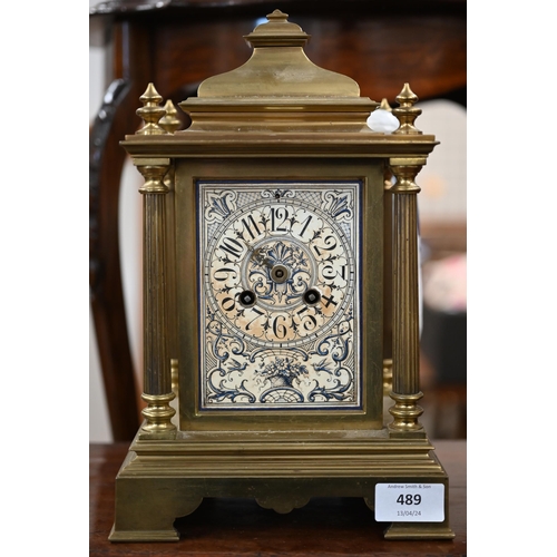 489 - A 19th century French heavy brass mantel clock with ornately decorated dial and side panels, the Jap... 