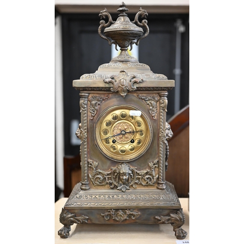 490 - A German brass cased mantel clock striking on a coiled gong 50 cm high oevrall to/w a slated marble ... 