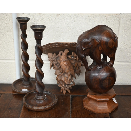 536 - A Black Forest wall bracket carved with a bird, 18.5 cm, to/w a pair of oak twist candlesticks and a... 