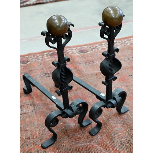 552 - Pair of wrought iron and copper fire dogs, to/w a cast iron fireside companion suit of armour (lacks... 