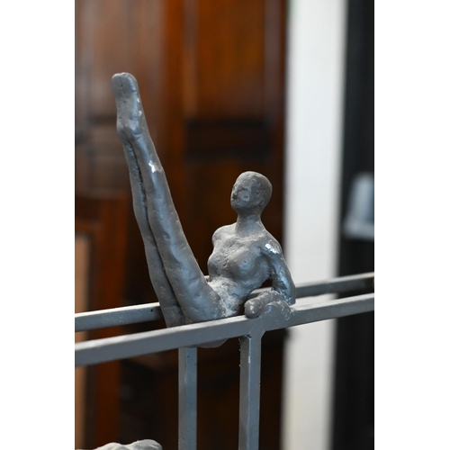 558 - A bronzed group, gymnasts on parallel bars, on marble base 36 x 65cm, to/w a composite lion wall-mas... 