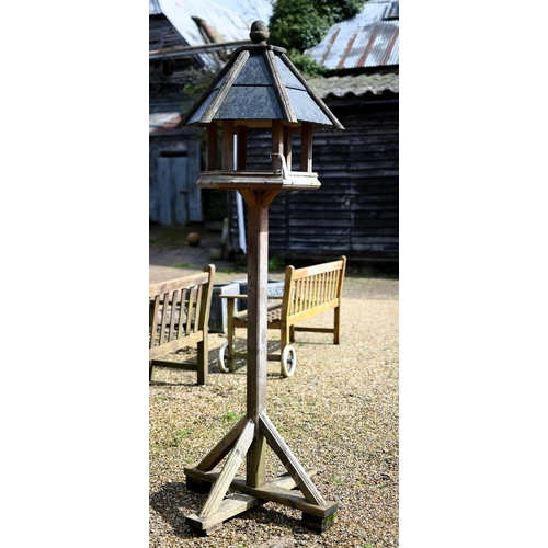 63B - A traditional bird house/feeder on stand, with slate roof