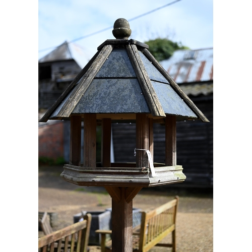 63B - A traditional bird house/feeder on stand, with slate roof