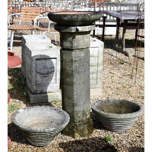 64 - A weathered cast stone column birdbath to/with a pair of conical form planters (3)