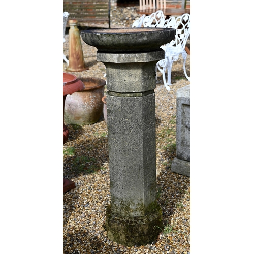 64 - A weathered cast stone column birdbath to/with a pair of conical form planters (3)